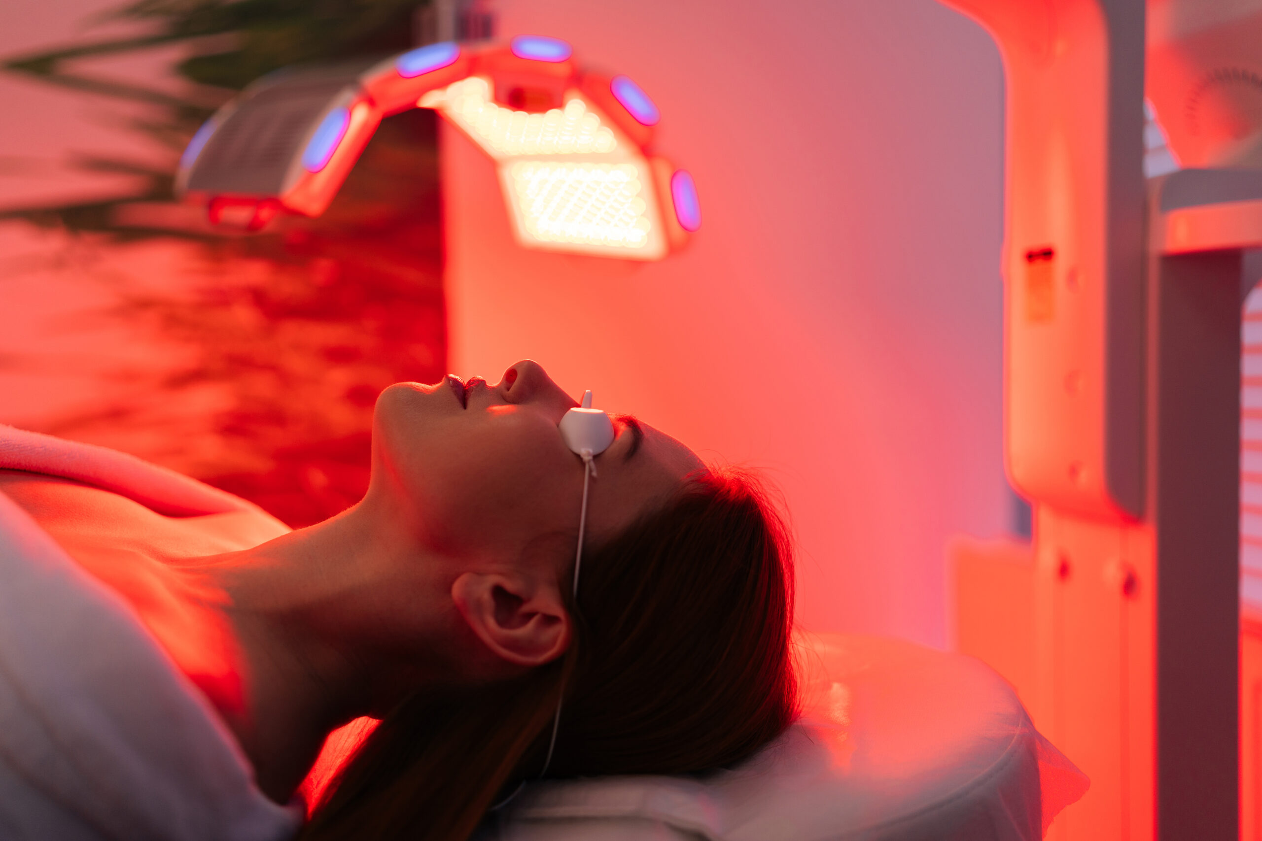 Close-up of patient receiving red LED light therapy treatment